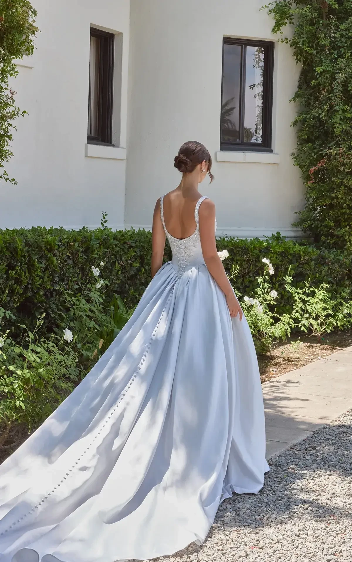 model is wearing a sleeveless satin ball gown 