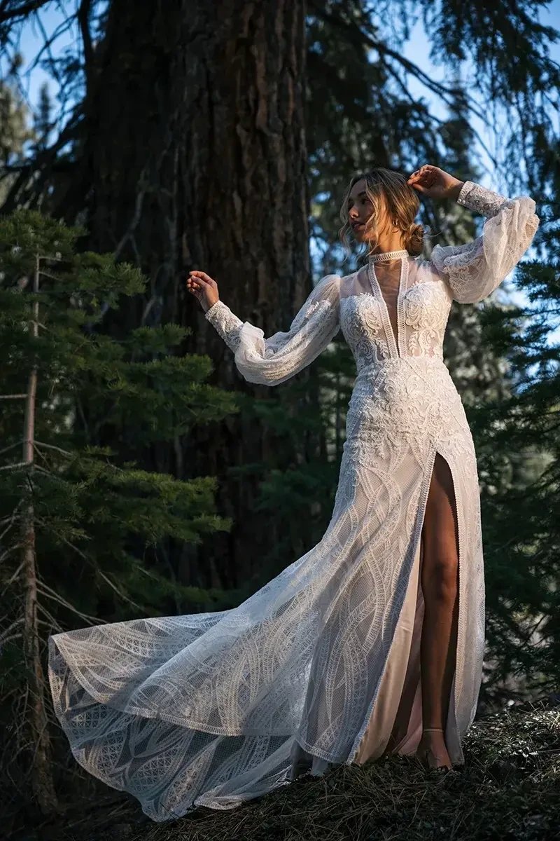 model is wearing a long sleeve boho wedding gown