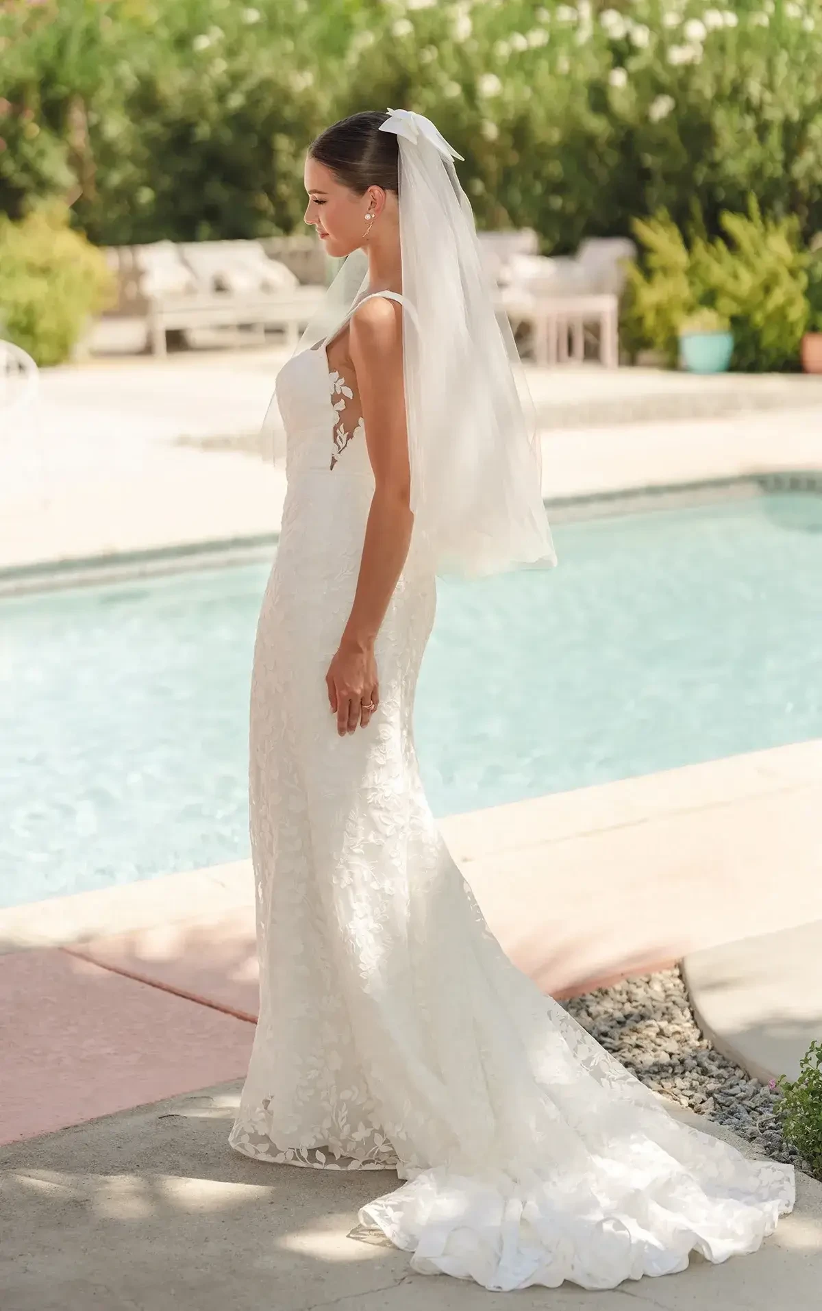 model is wearing a sleeveless lace wedding dress